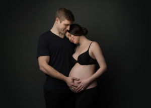 intimate maternity couples portrait cradling pregnant belly