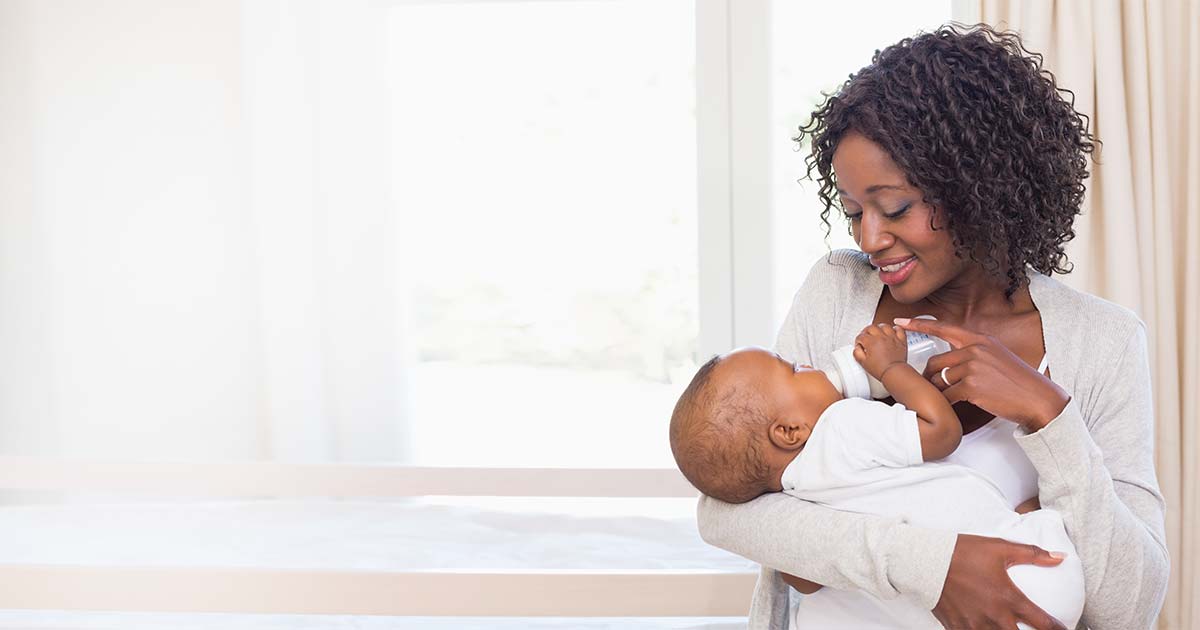 A mother feeding her baby with a bottle