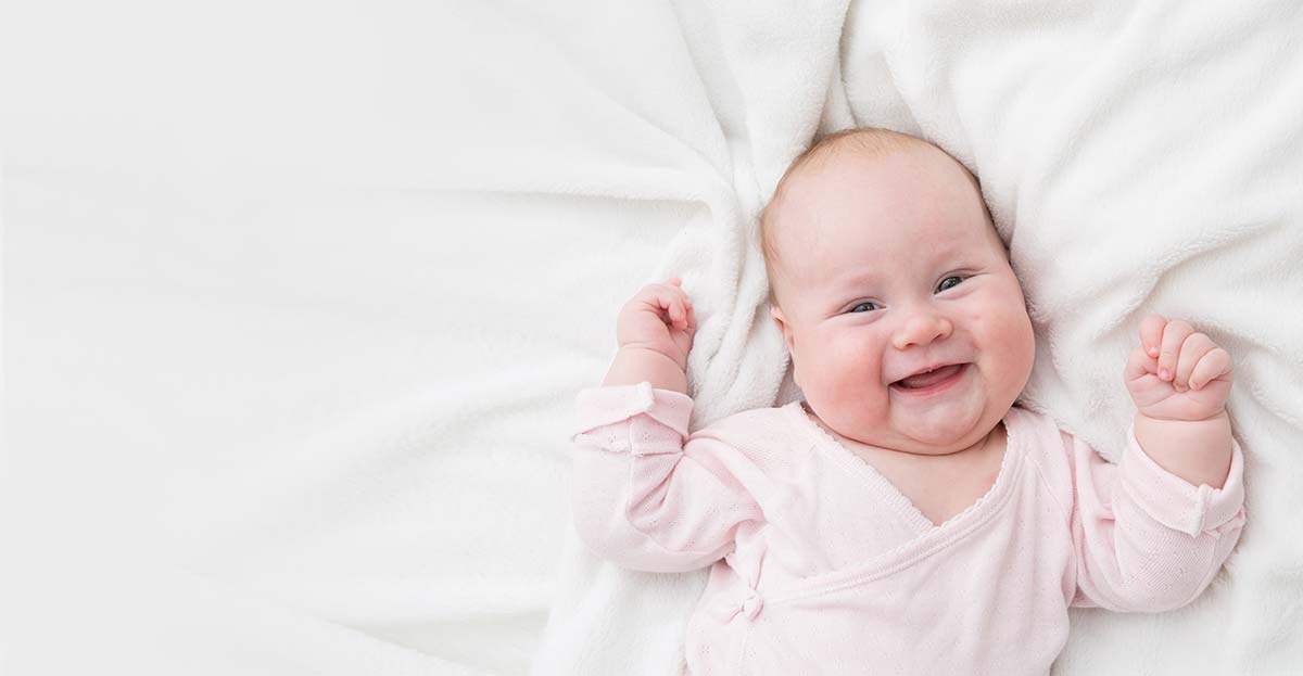 Happy baby smiling in bed