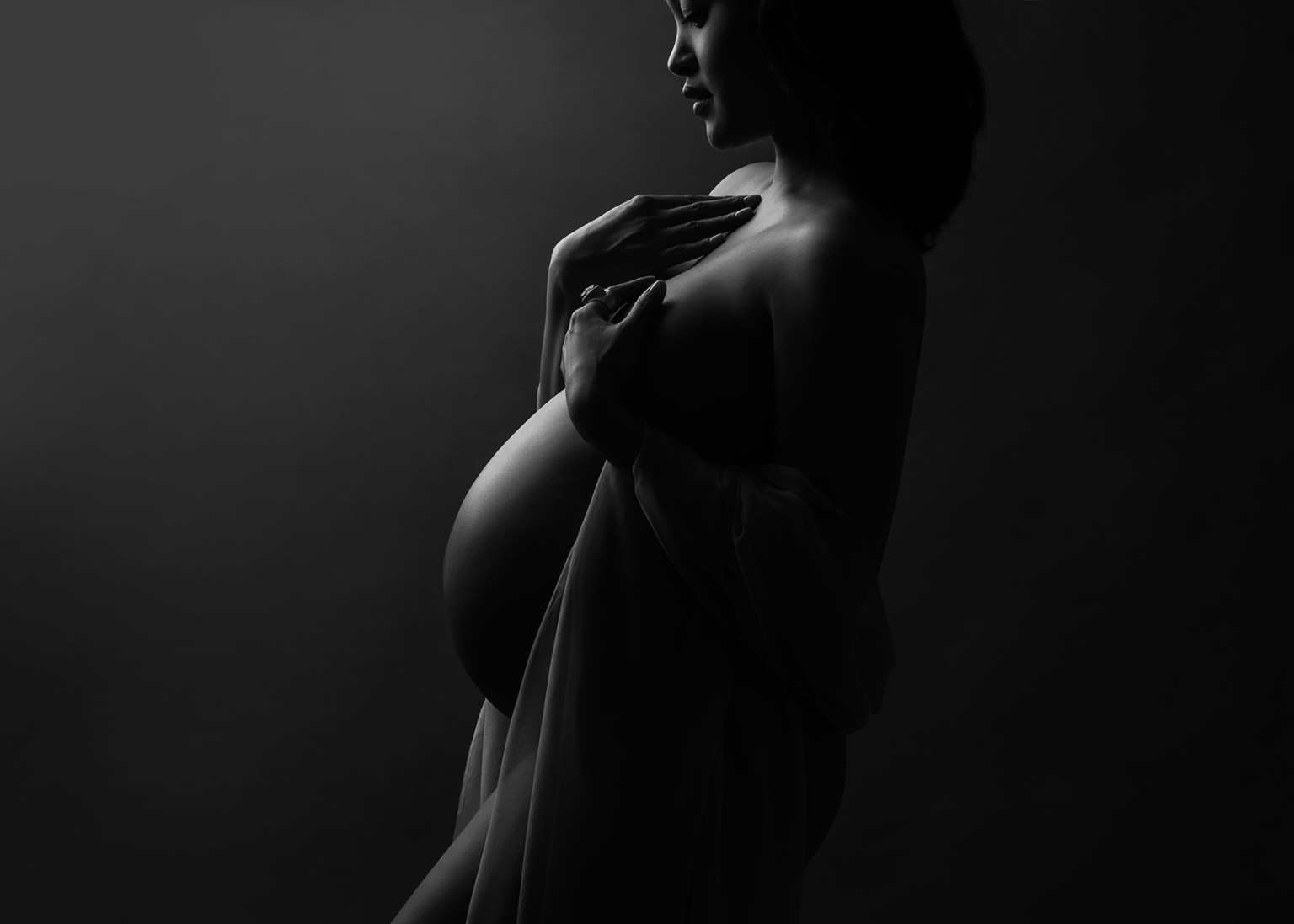 Silhouette photo showing the contours of a pregnant woman