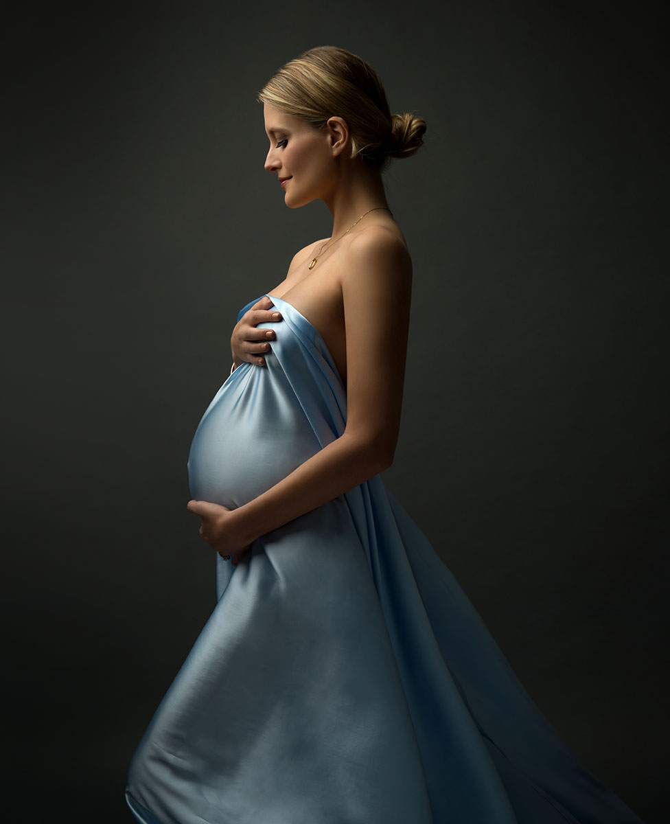 Stunning blue dress worn by a maternity model
