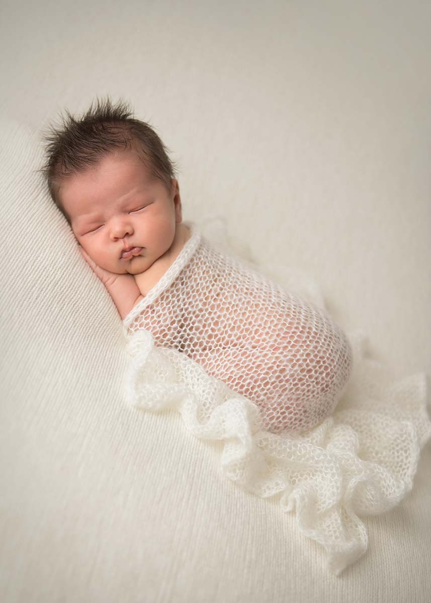 Cute newborn baby sleeping at a photography studio