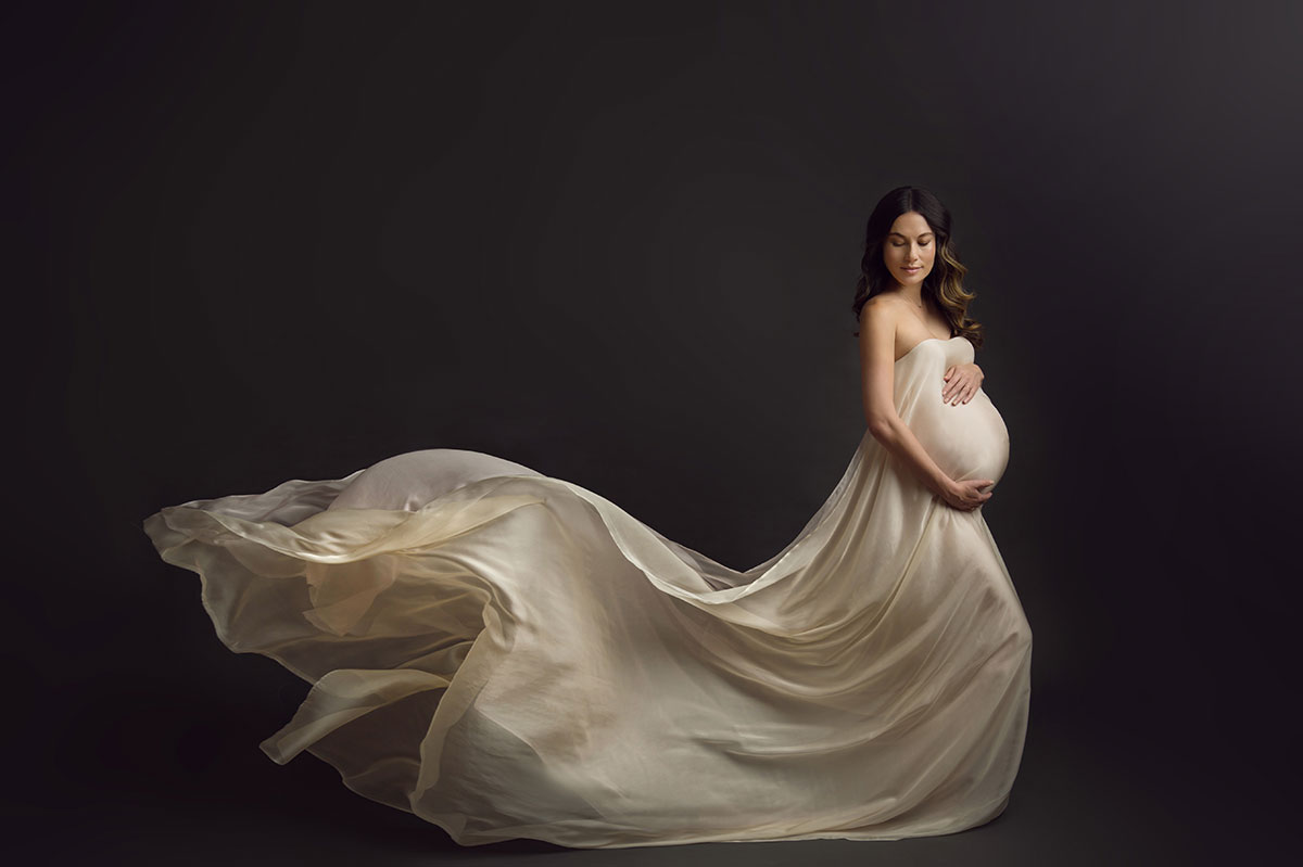 Pregnant model posing for a maternity photo at a NYC studio