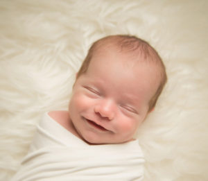 smiling NYC infant baby at a photo studio