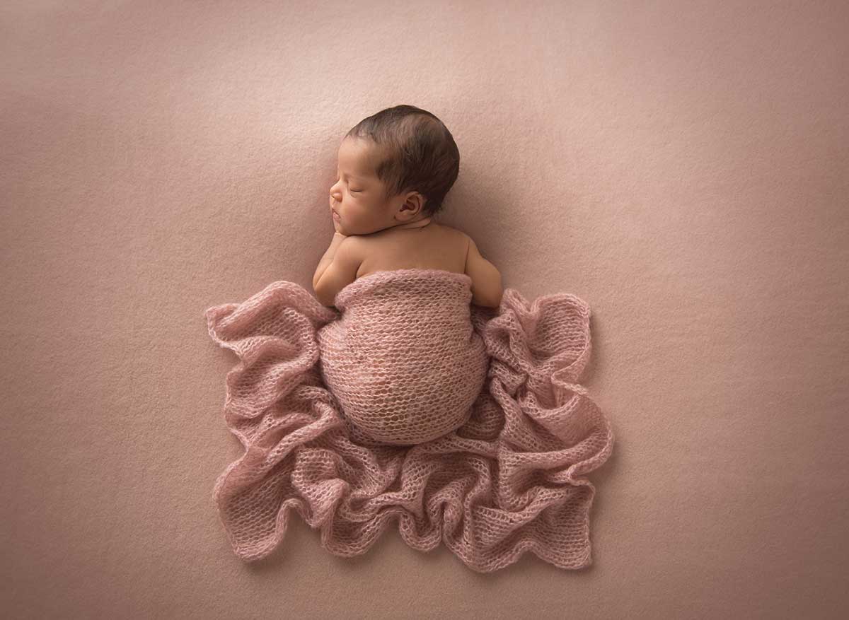 Newborn photo of a NYC infant sleeping on a blanket
