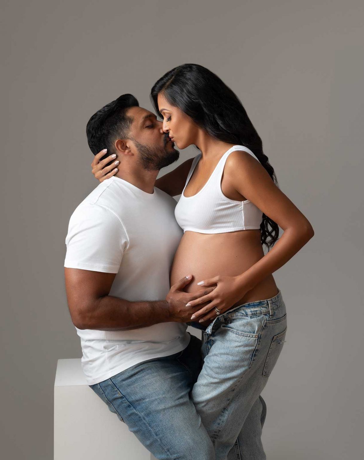timeless couples maternity portrait of kissing parents in love