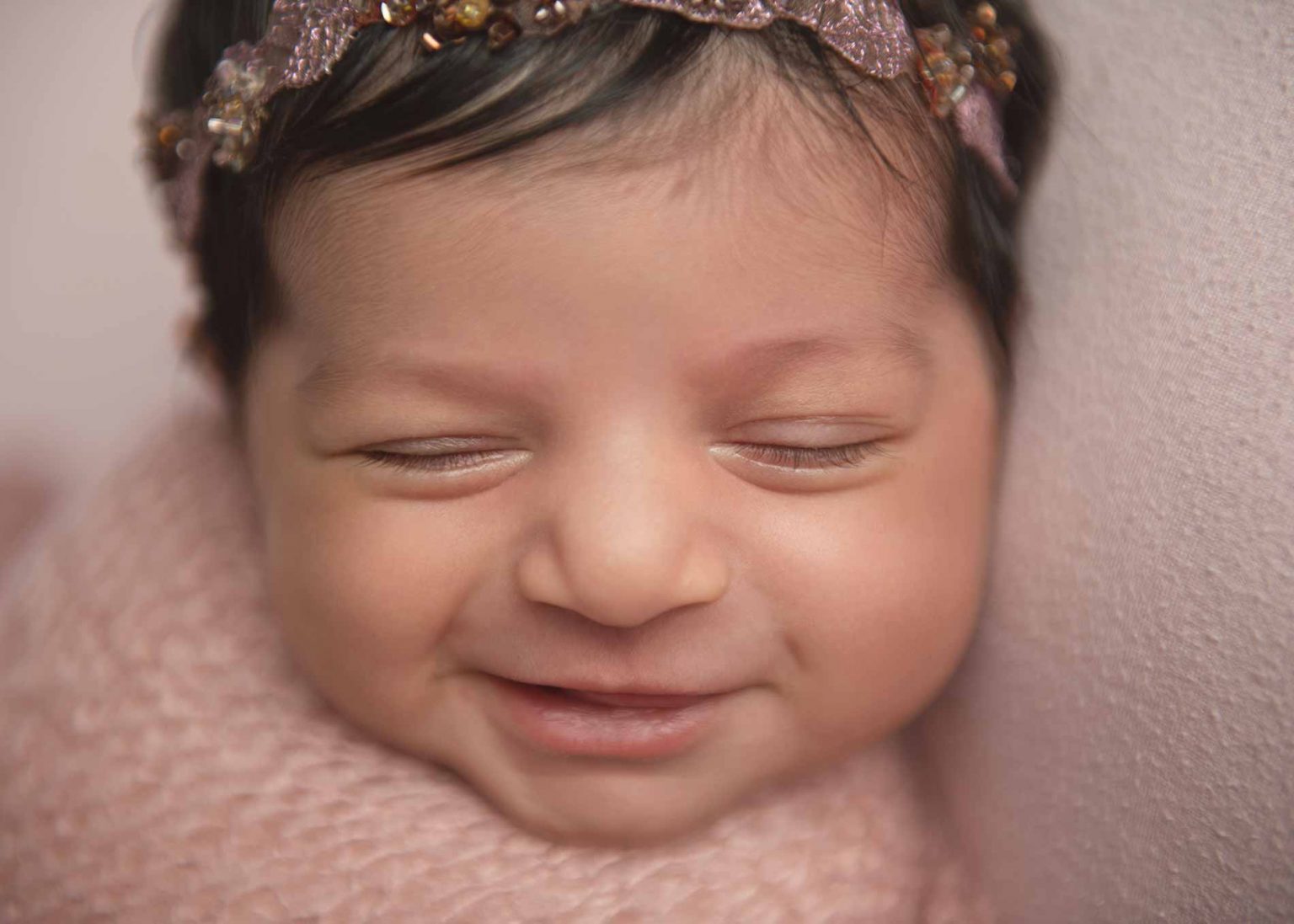 Closeup of a newborn girl smiling