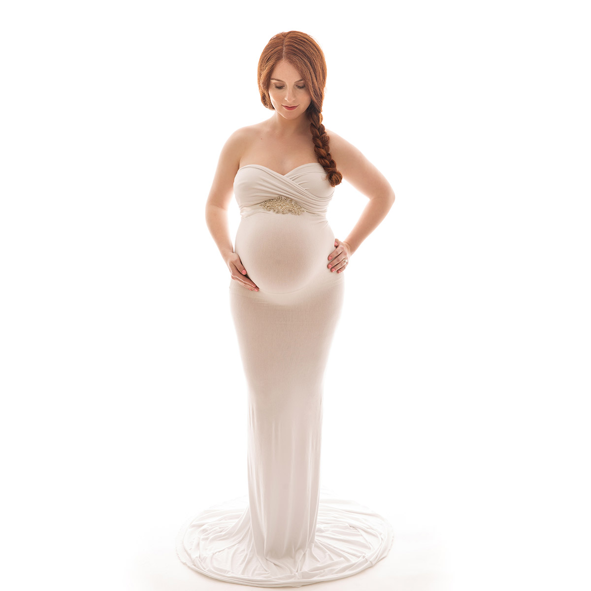 Professional maternity portrait of a woman with red hair and a white dress