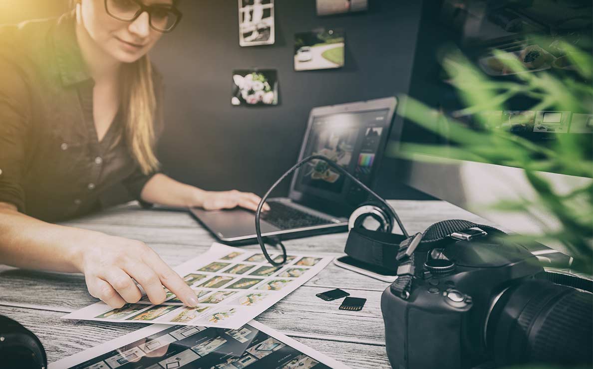 Woman curating her photographs at a desk