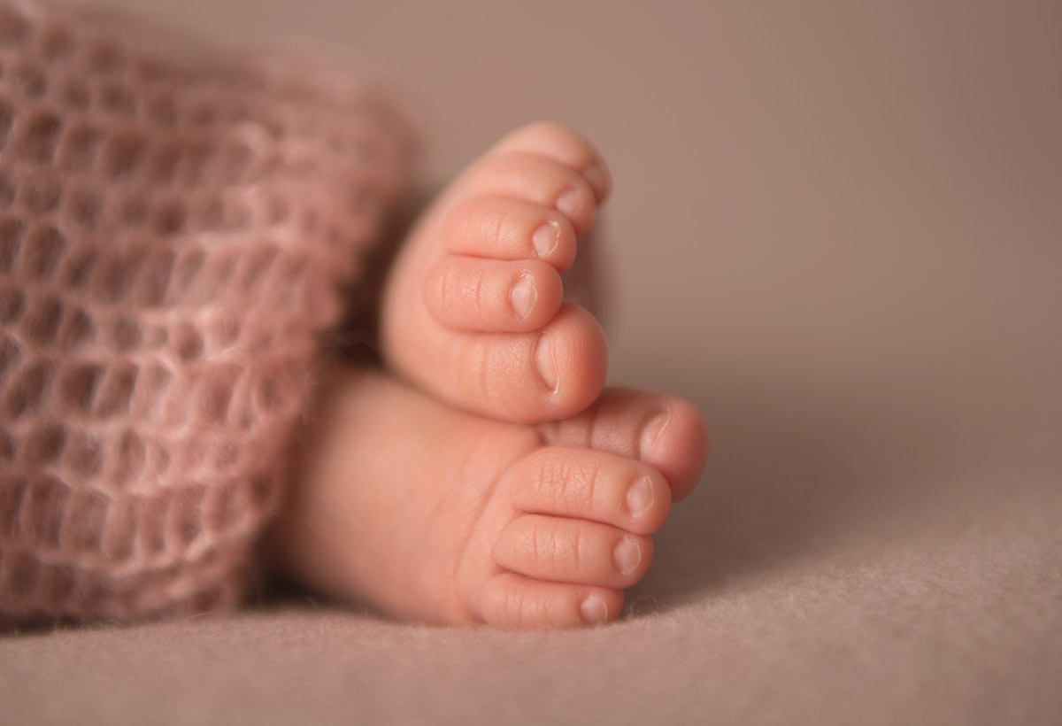 Closeup image of infant's toes wrapped in a swaddle
