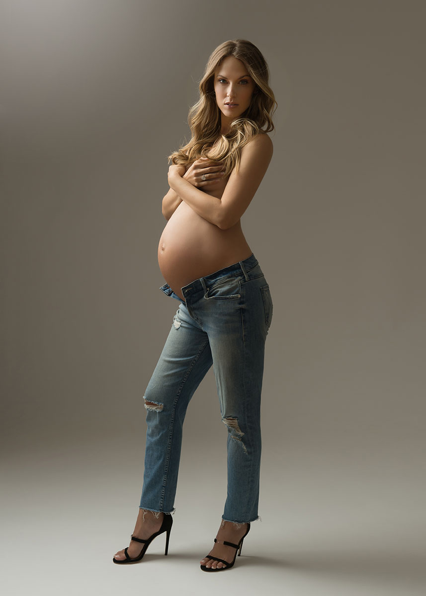 Stylish woman showing off her pregnant belly