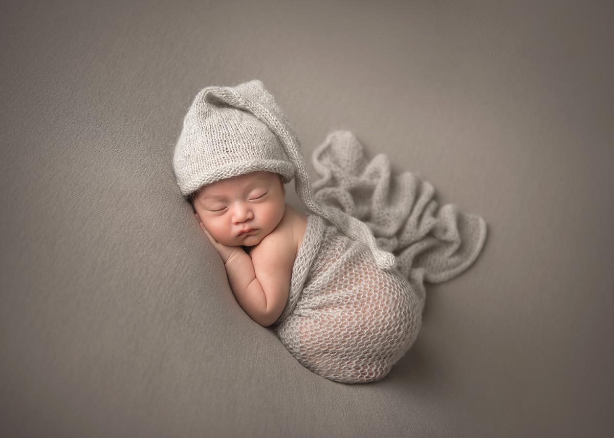 Knit hat on a sleepy newborn