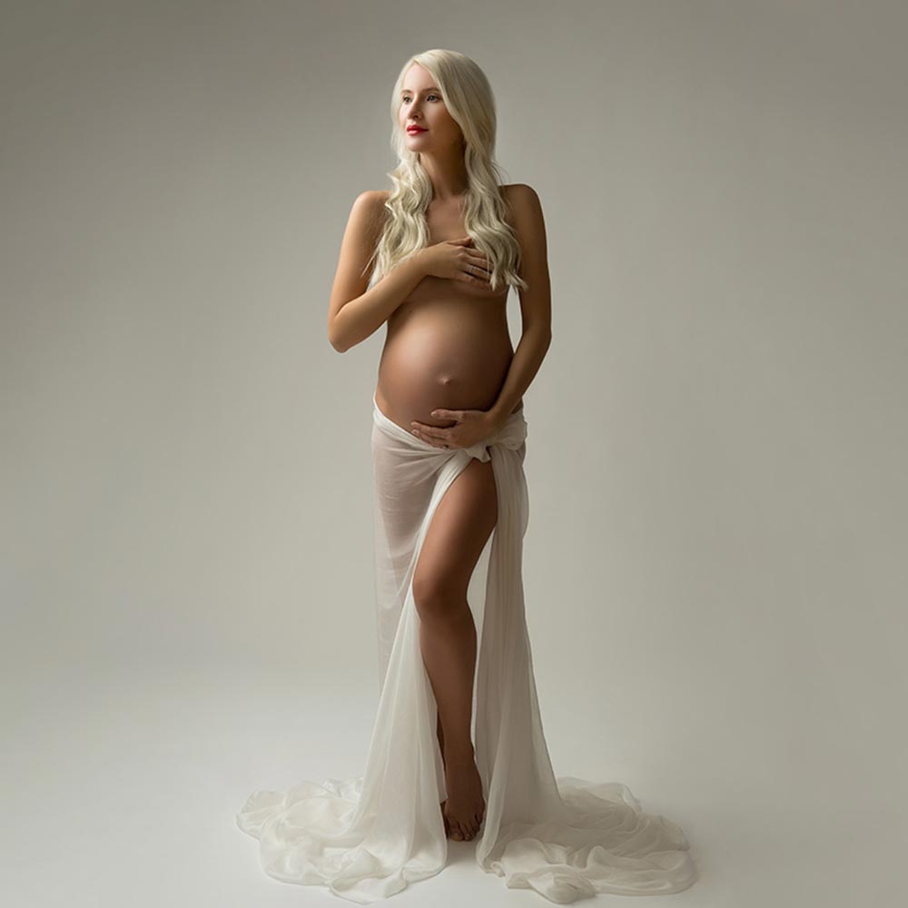 Blonde woman cradling her pregnant belly
