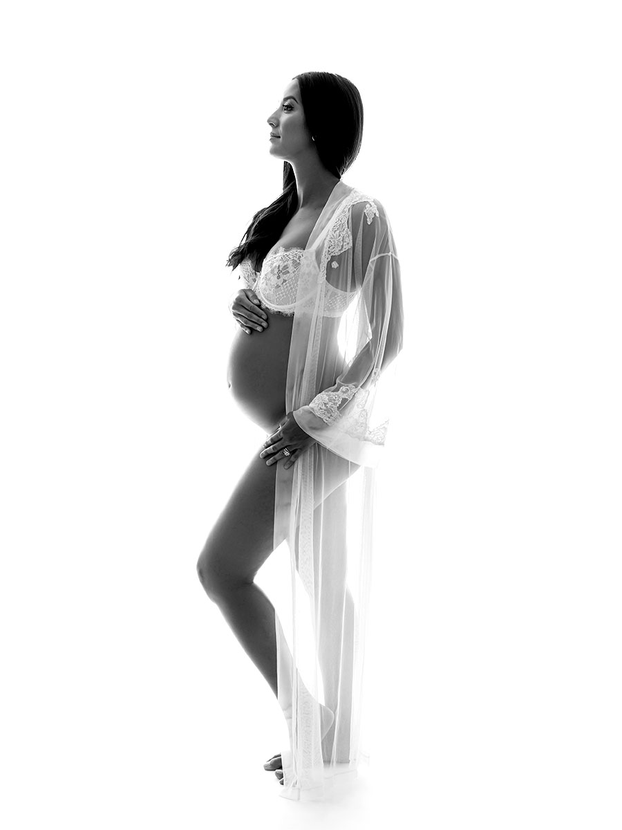 White lace dress worn by a pregnant woman