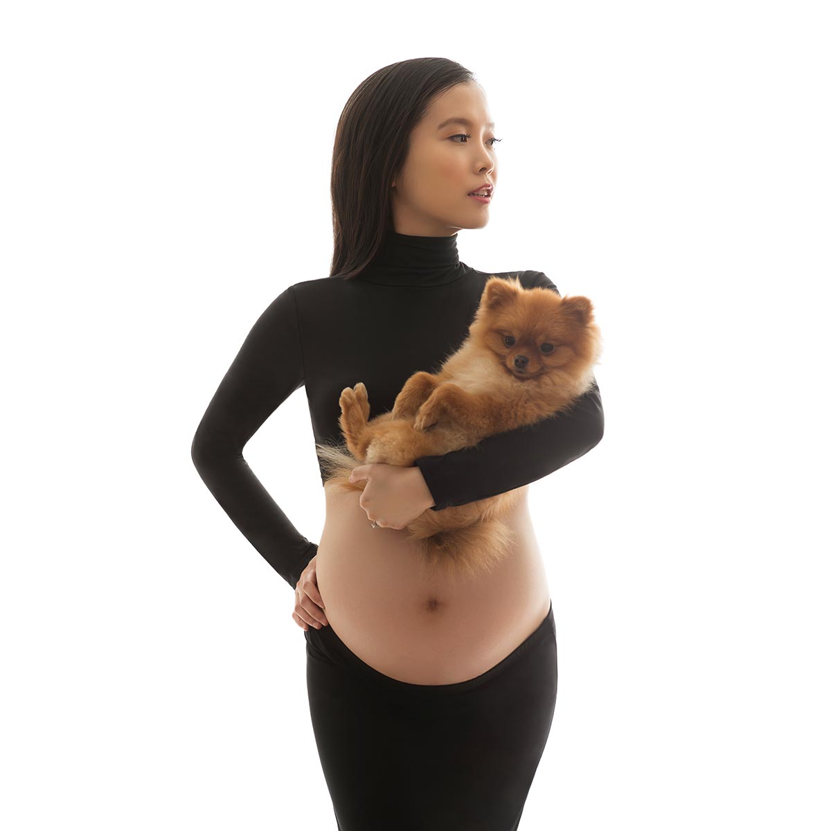 Pregnant woman holding a cute dog