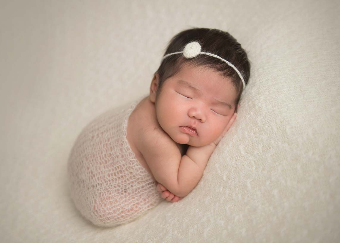 Sleeping newborn with a cute headband