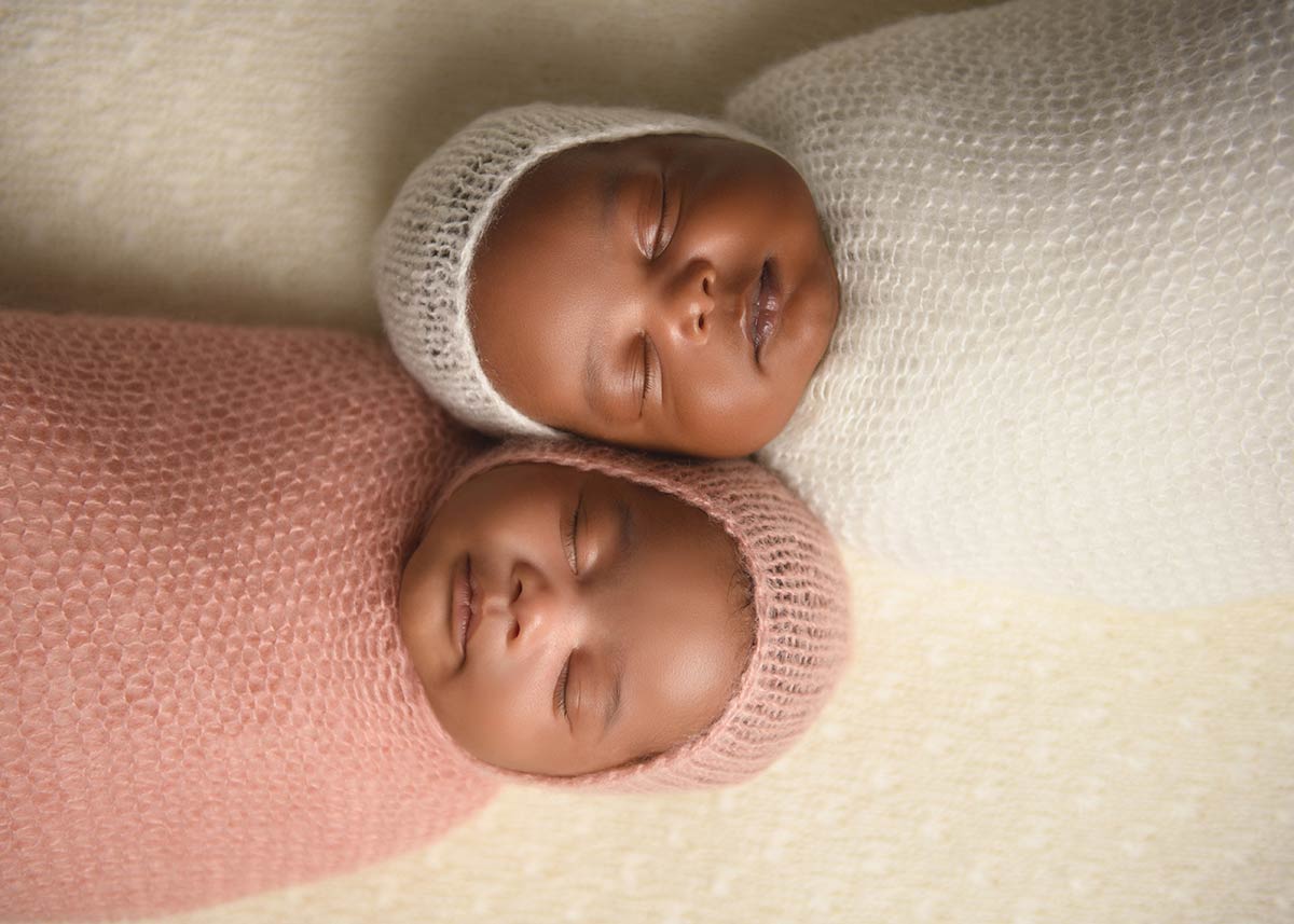 Adorable newborn twins sleeping together