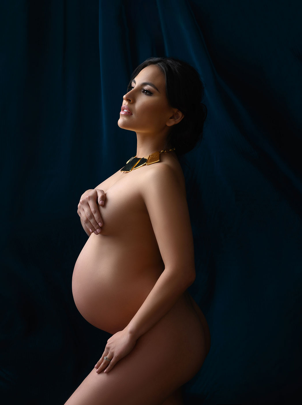 blue velvet backdrop for nude pregnancy portrait with gpld statement necklace