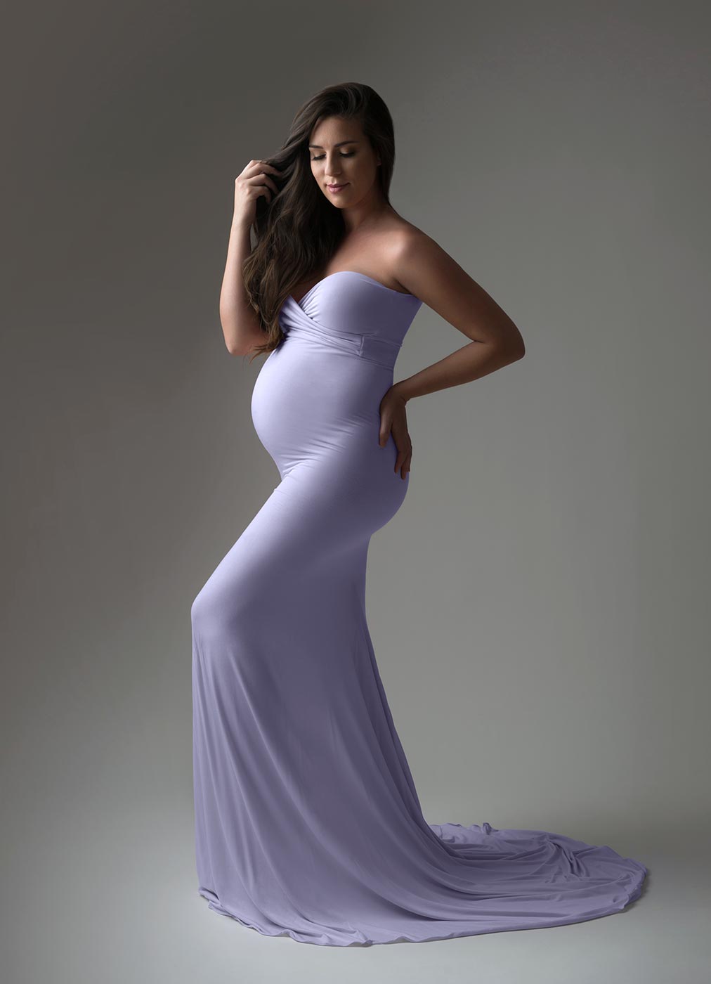 beautiful lavender dress pregnant woman playing with her hair