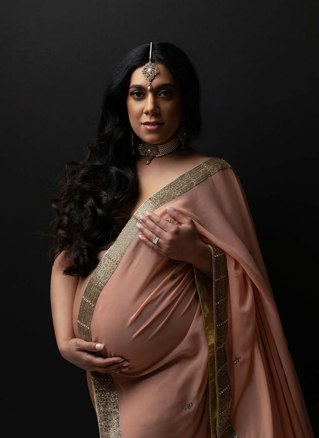 fine art traditional blush gold saree draped on pregnant woman for timeless maternity portrait