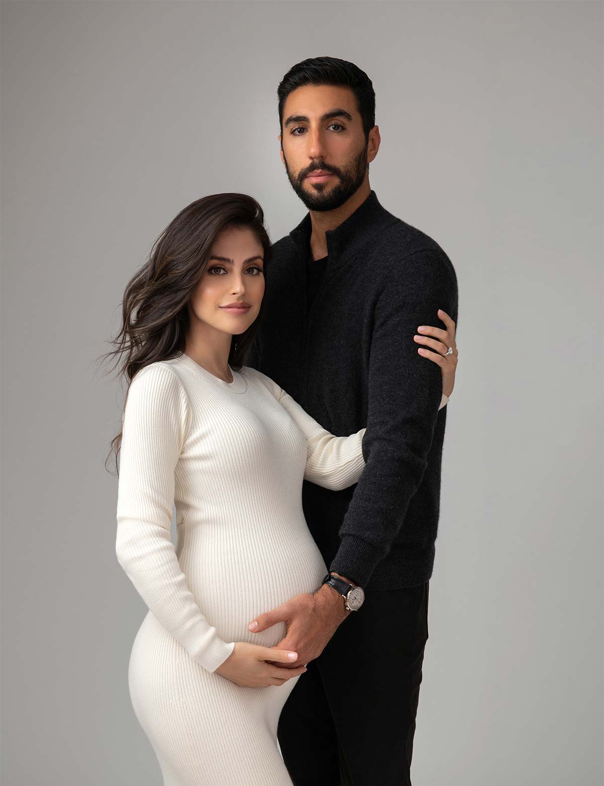 Husband cradling his wife's pregnant belly