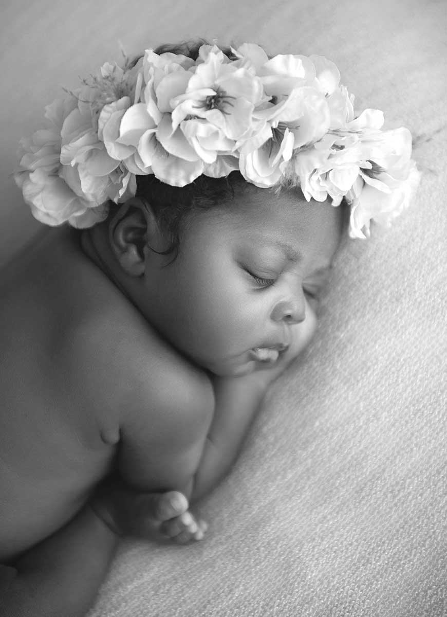 Newborn baby with a flowery headband