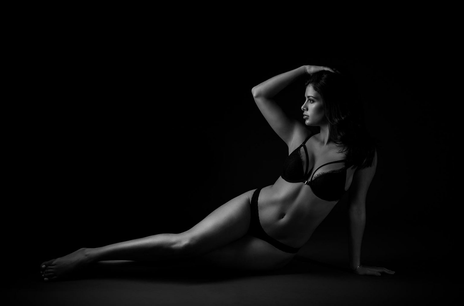 Woman in lingeries posing at a dark NYC photo studio