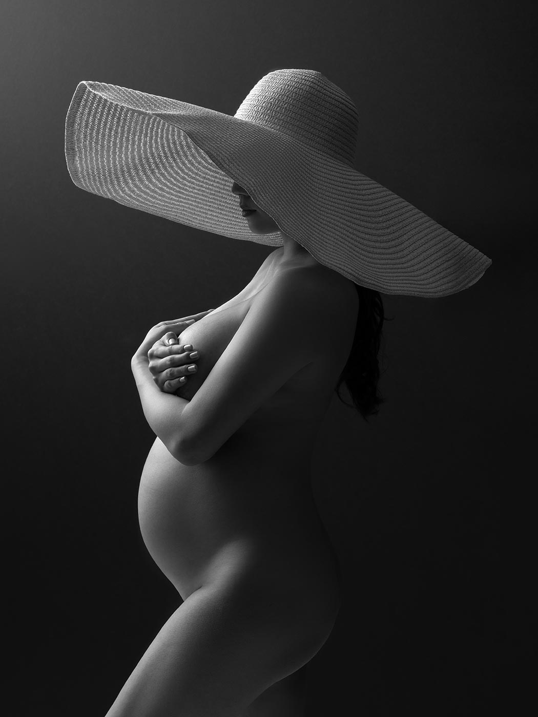 Broad hat worn by a pregnancy model at a photo studio in NYC