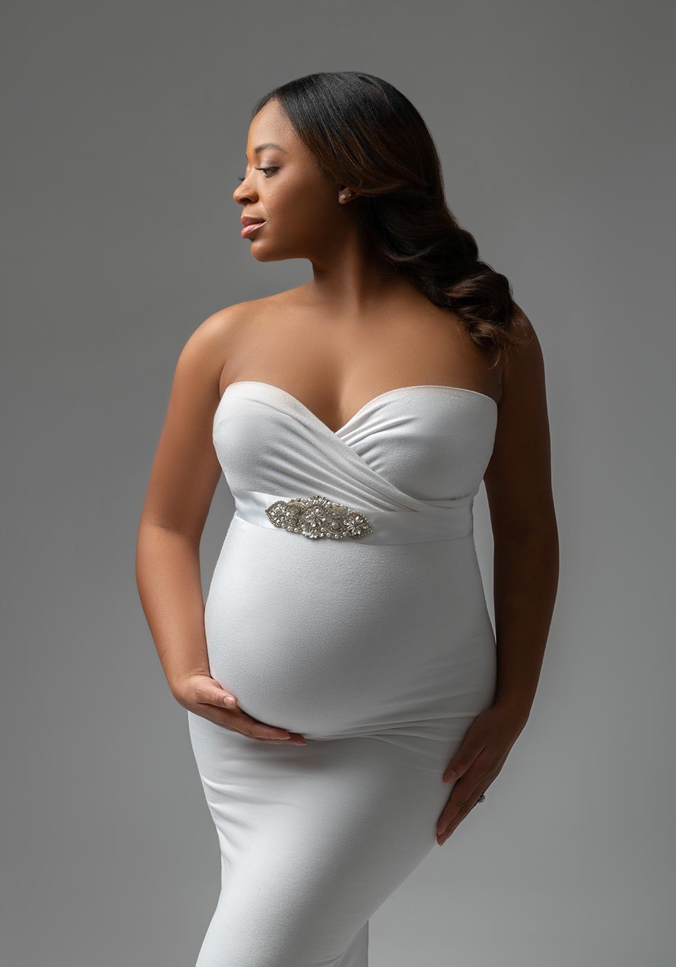 beautiful white dress worn by a pregnant woman in NYC studio