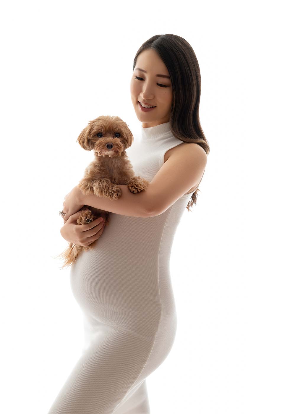 Maternity model holding a puppy