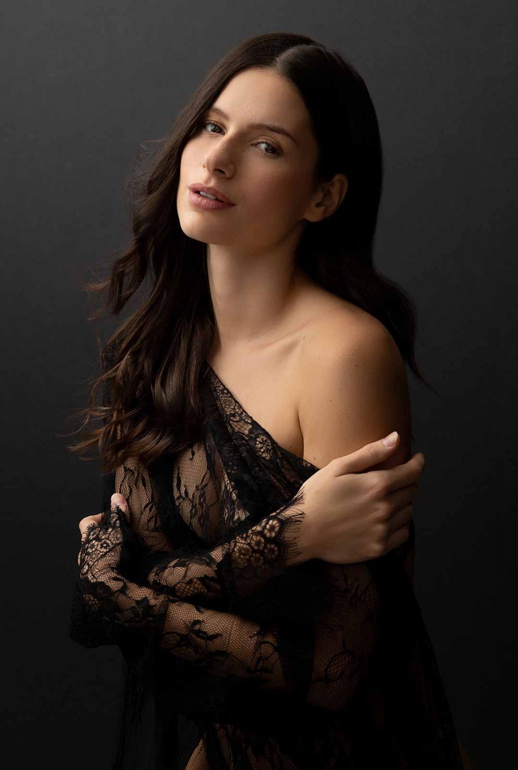 Low key portrait of a woman on dark backdrop