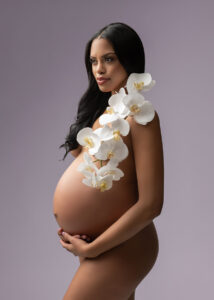 Implied nude of pregnant woman with orchids