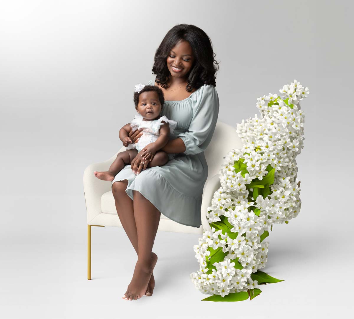 Mother and her baby posing for a Mother's Day portrait at a NYC studio