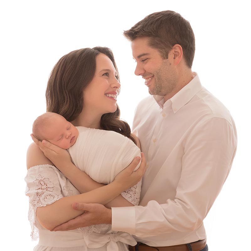 Family portrait with a cradled newborn baby taken in NYC