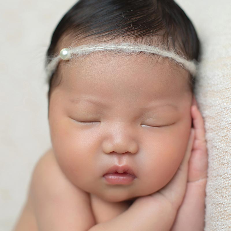 Closeup of a sleeping newborn with pouty lips